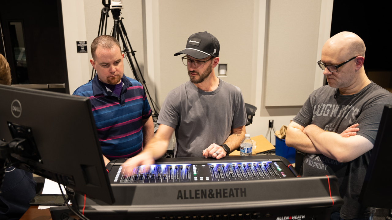 A Churchfront consultant working through a sound console with a church tech team