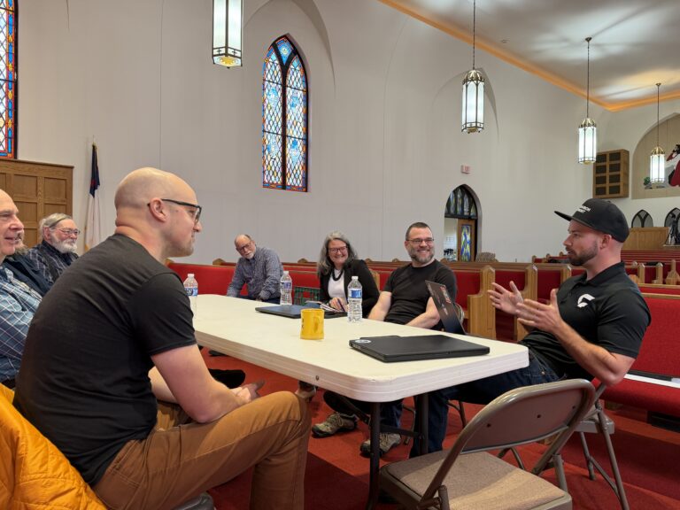 A Churchfront consultant at a table with church leaders during a discovery session