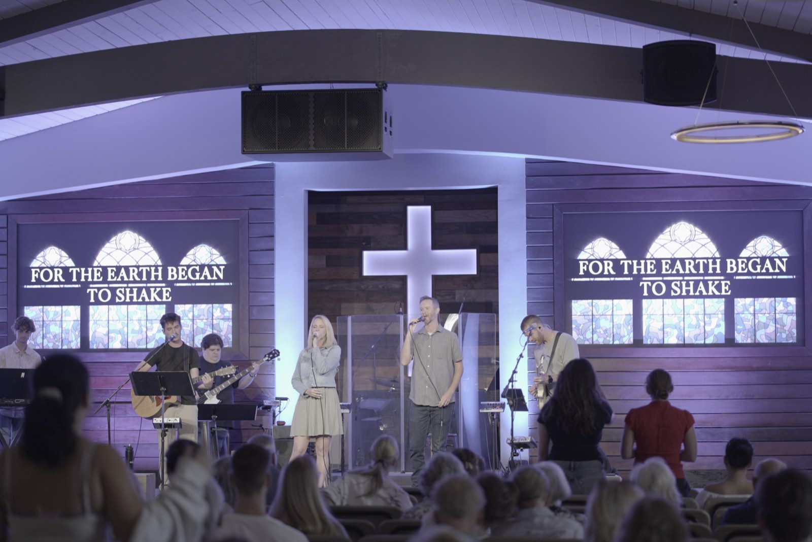 Worship team at Agoura Bible Fellowship in front of the center and side LED screens showing a stained glass graphic