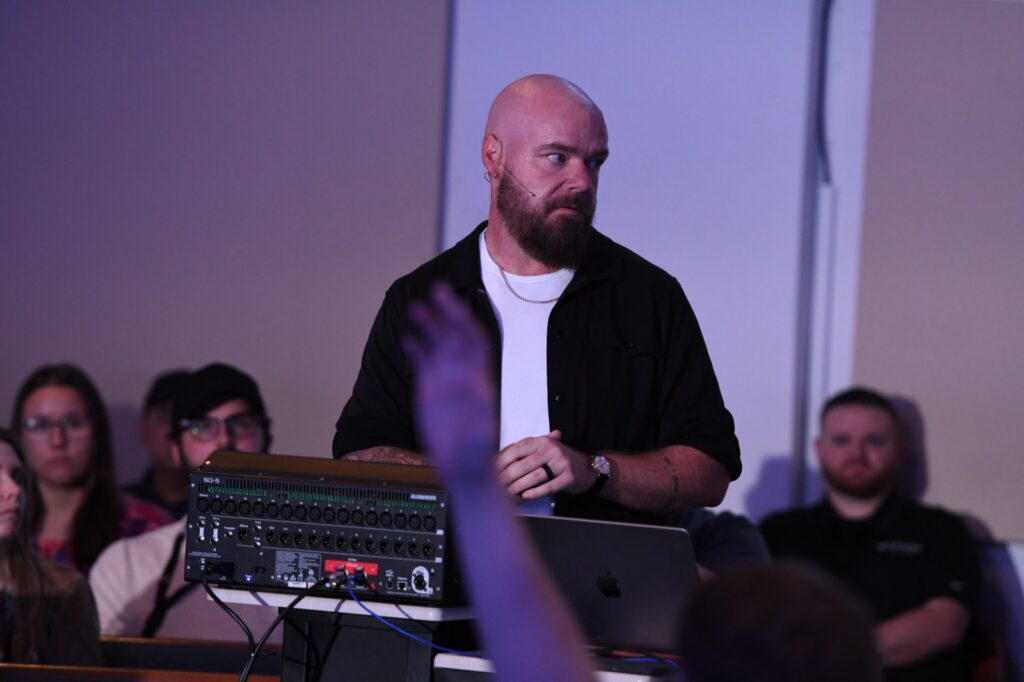 Breakout instructor at a digital mixing console taking a question at the Churchfront Conference