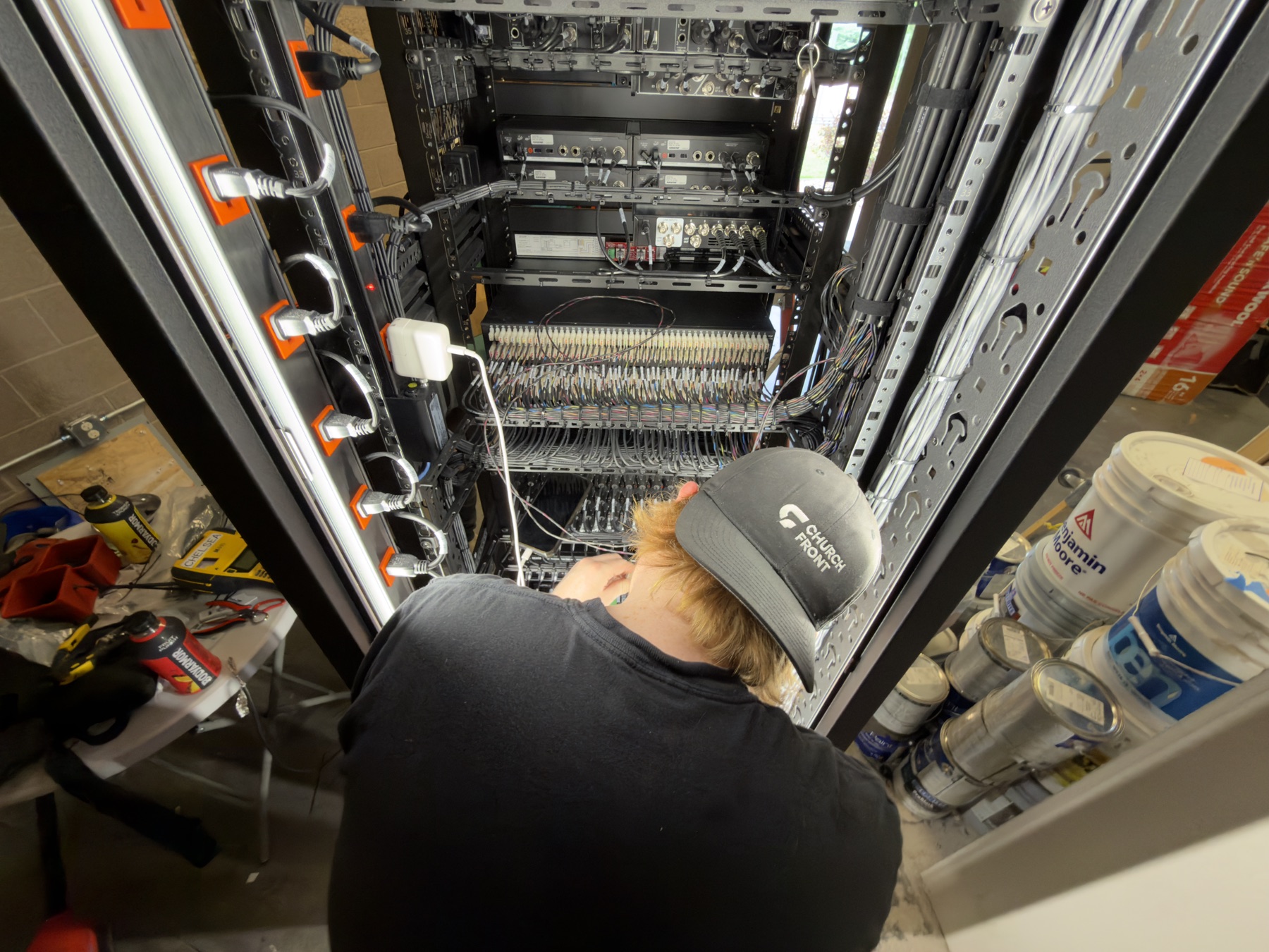 A Churchfront technician wiring an equipment rack on site