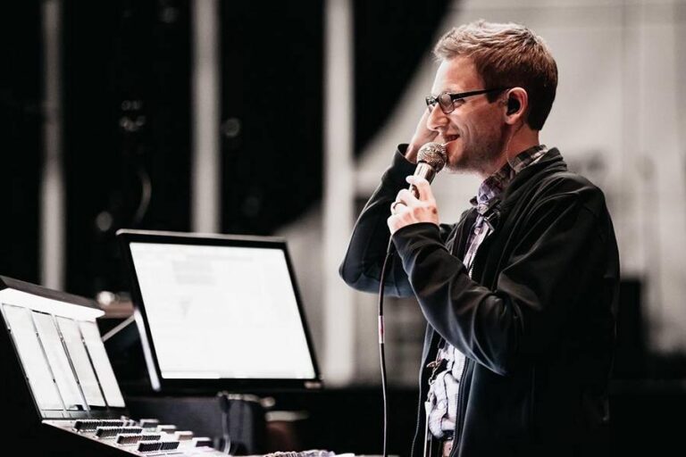 Drew Brashler speaking at a mixing console, Churchfront Conference 2026 keynote speaker