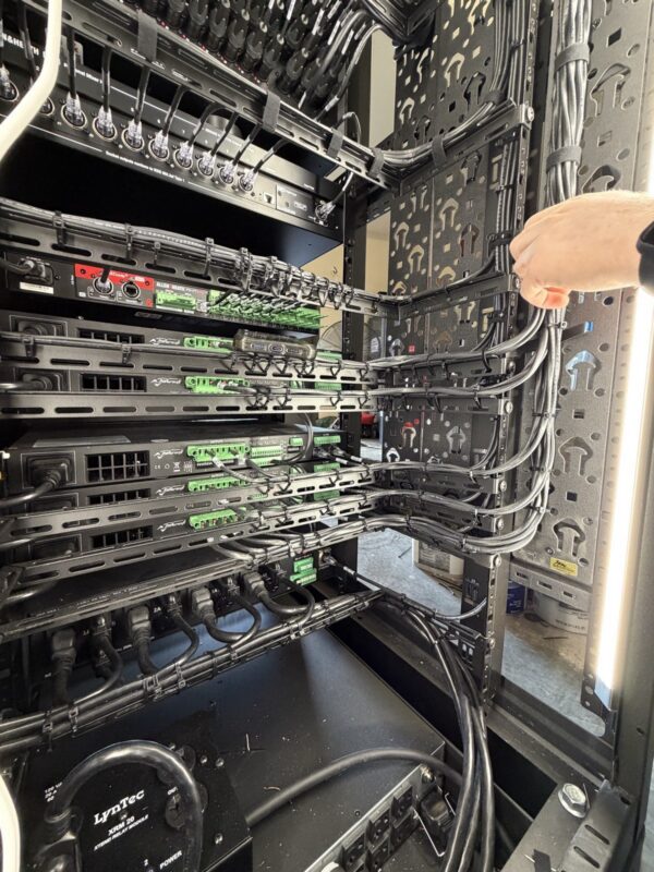 Rear of an audio equipment rack with dressed and labeled cabling