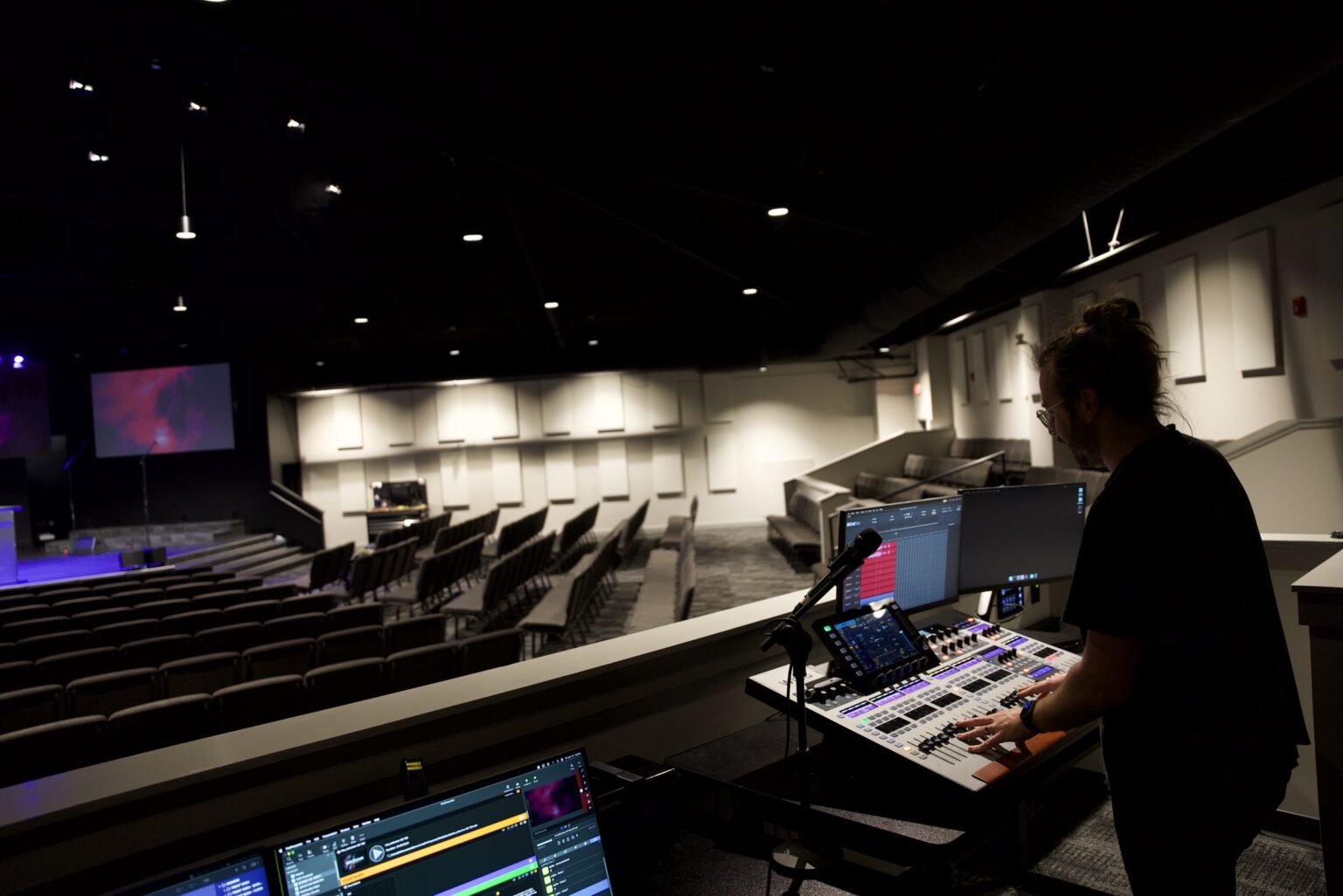 Volunteer mixing a worship service at a front of house digital console