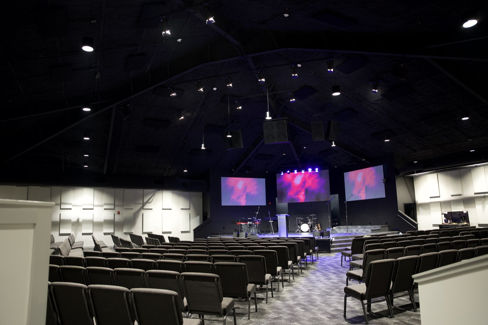 Faith Covenant Church of God sanctuary from the center aisle with the LED wall, side projection screens and stage