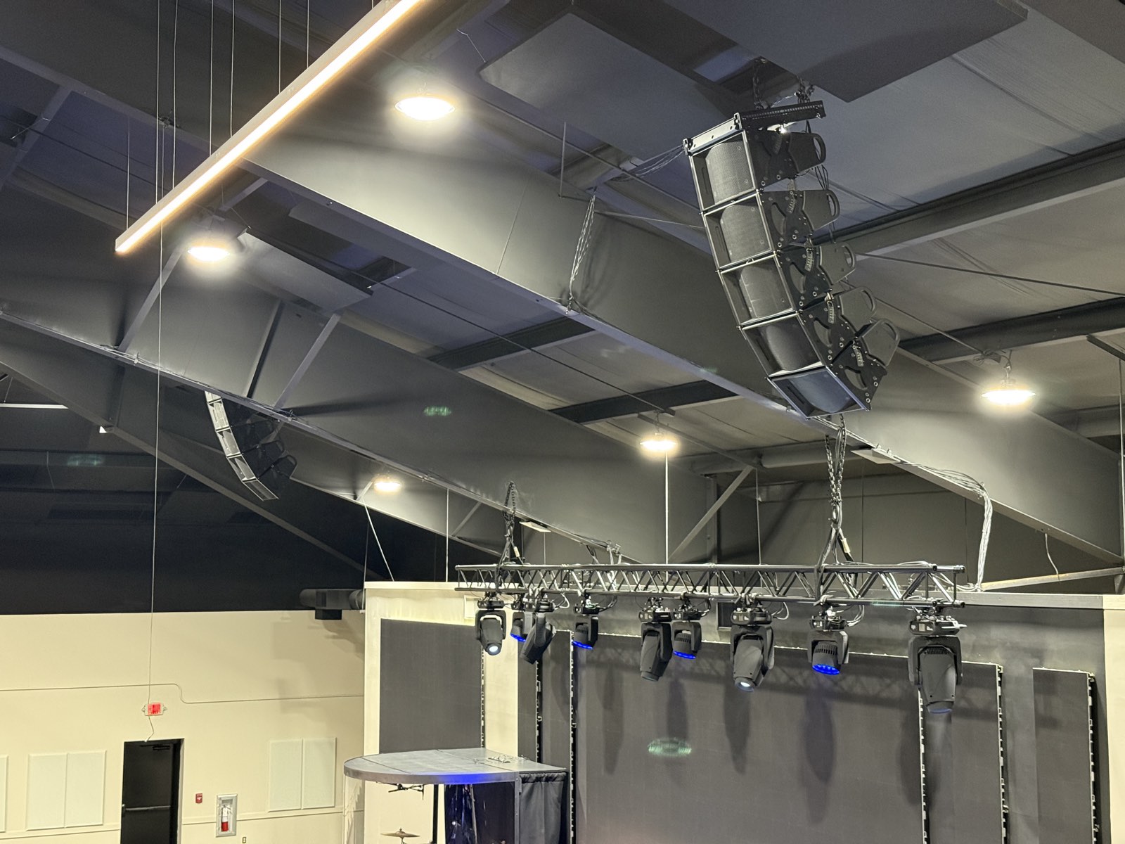 Fulcrum Acoustic line array hung from the ceiling beside a lighting truss of moving fixtures at First Baptist Church Pontotoc
