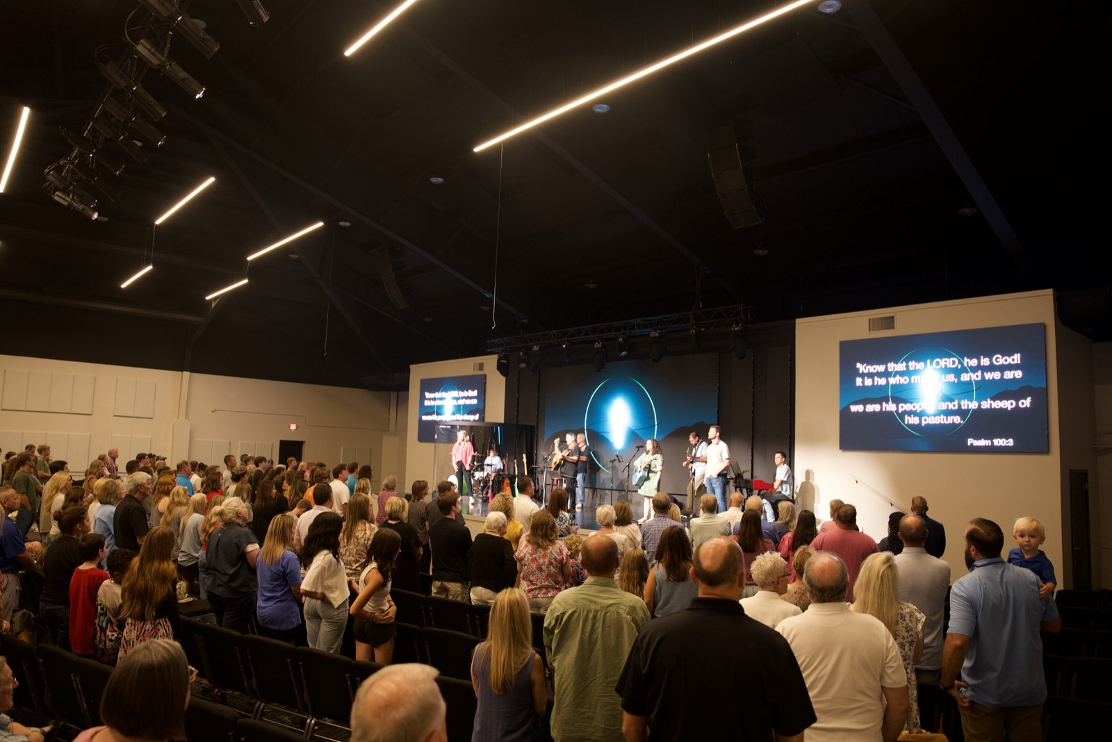 Congregation standing in worship at First Baptist Church Pontotoc with scripture on the side LED screen