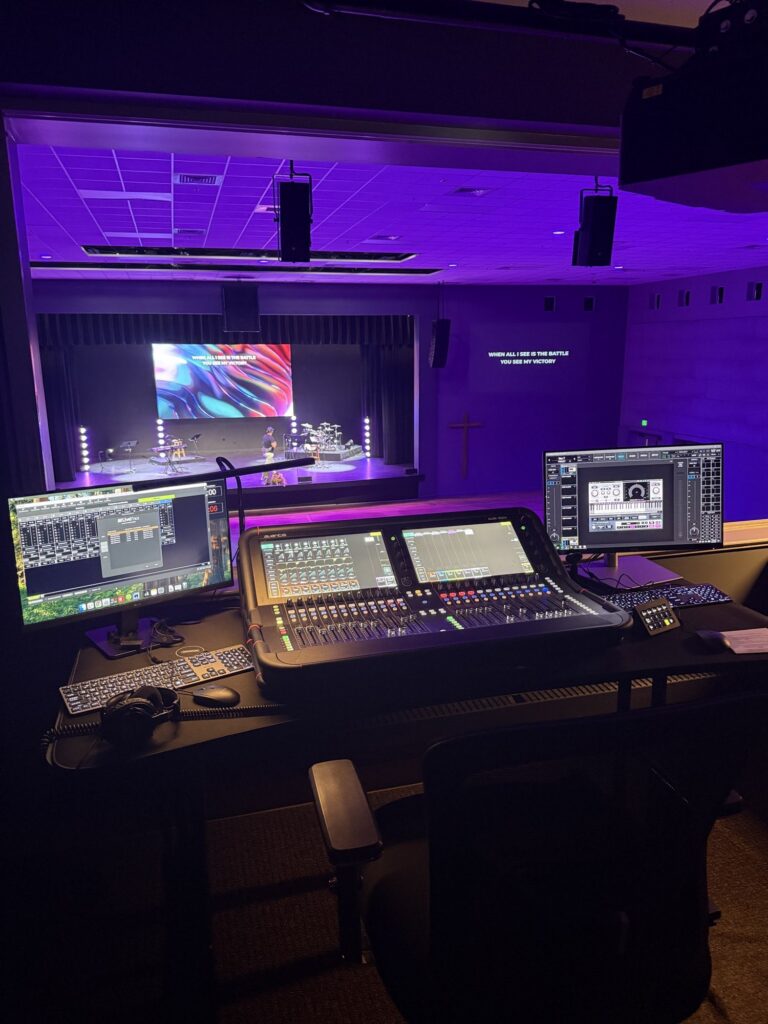 Front of house mixing position with a digital console laid out for a volunteer operator