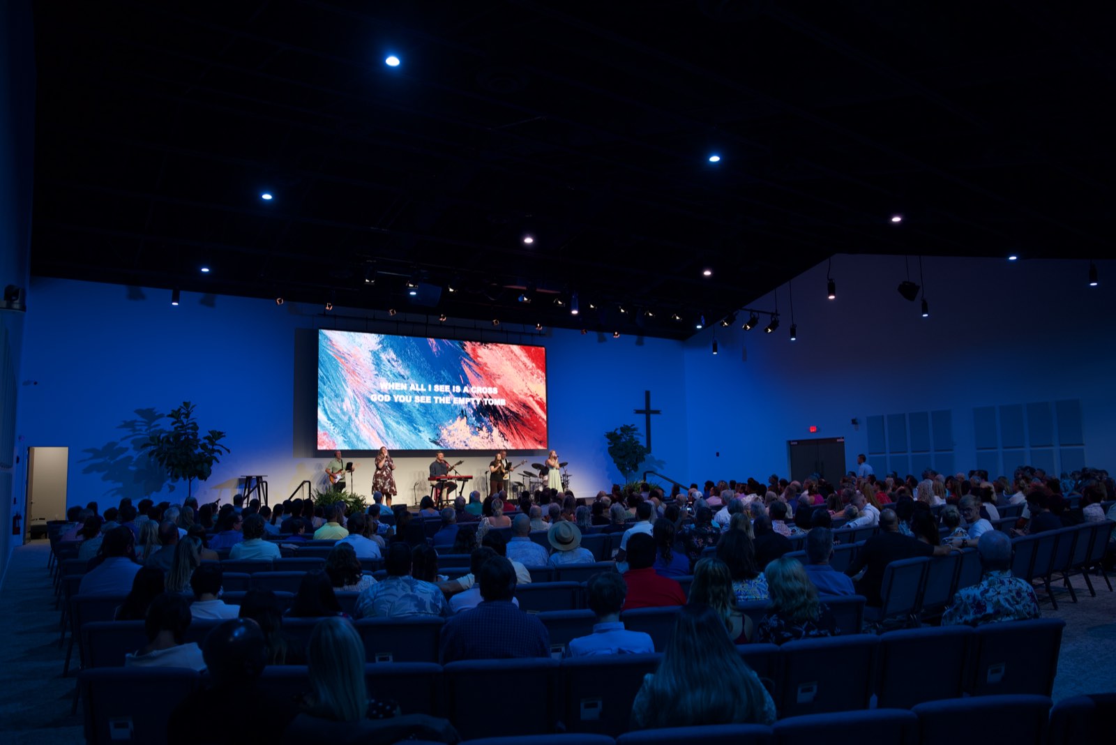 Island Community Church congregation in worship facing the LED wall, seen from the rear of the room