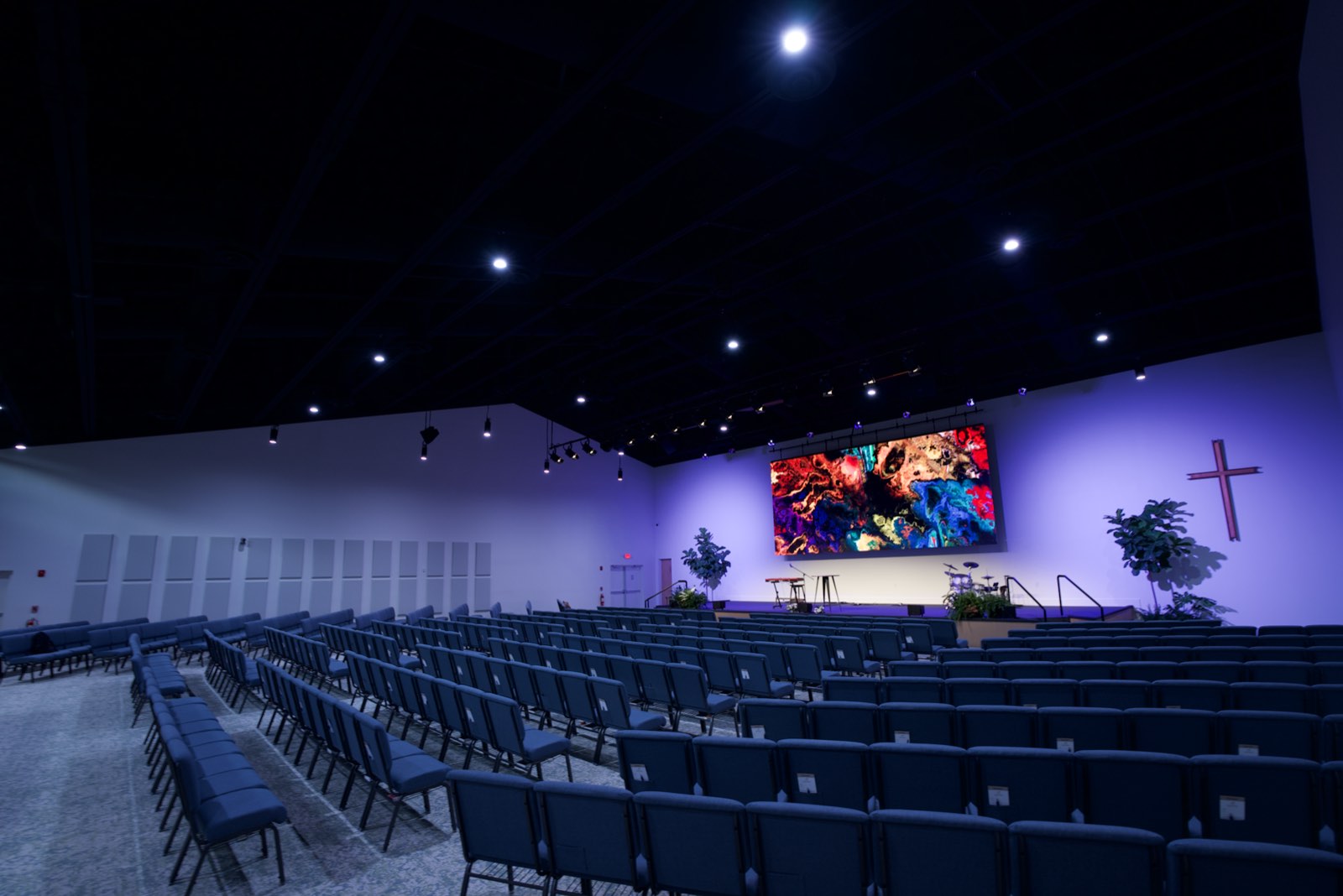 Island Community Church worship center with light walls, linen acoustic panels, and a flown LED wall above the stage