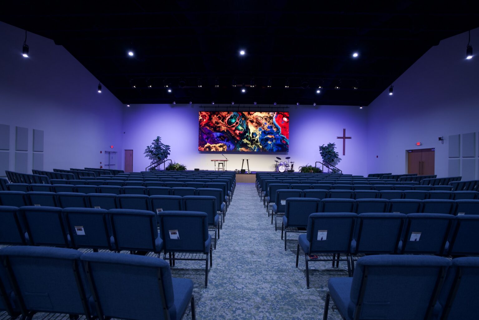 Church sanctuary with a center LED wall seen from the back of the room