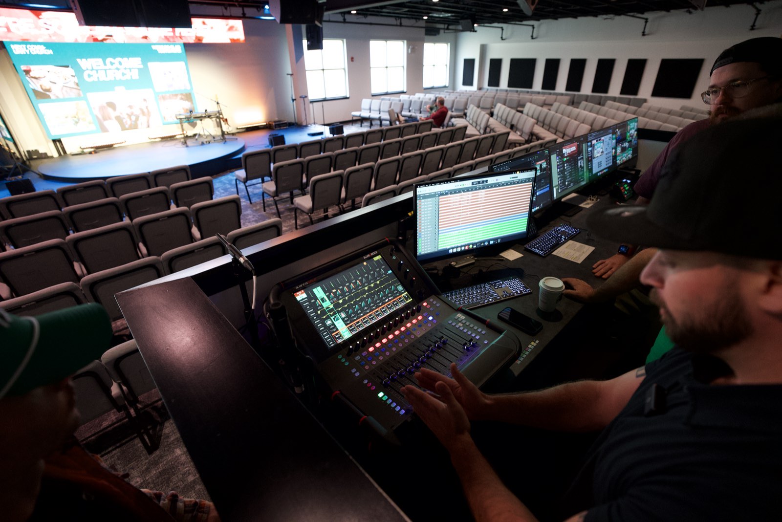 Volunteer operating the digital mixing console at front of house at Next Community Church