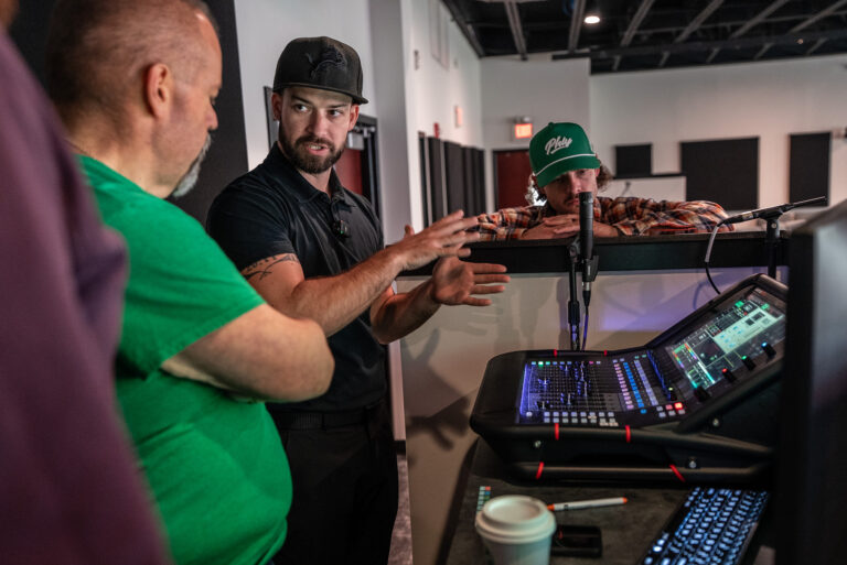 A Churchfront engineer coaching a church volunteer at the console