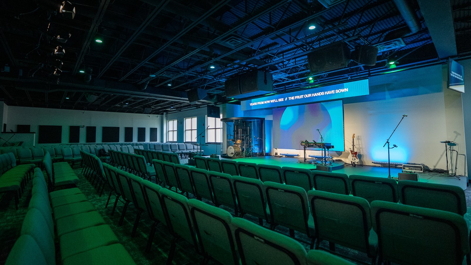 Next Community Church worship room converted from office space, with acoustic wall panels and ceiling clouds