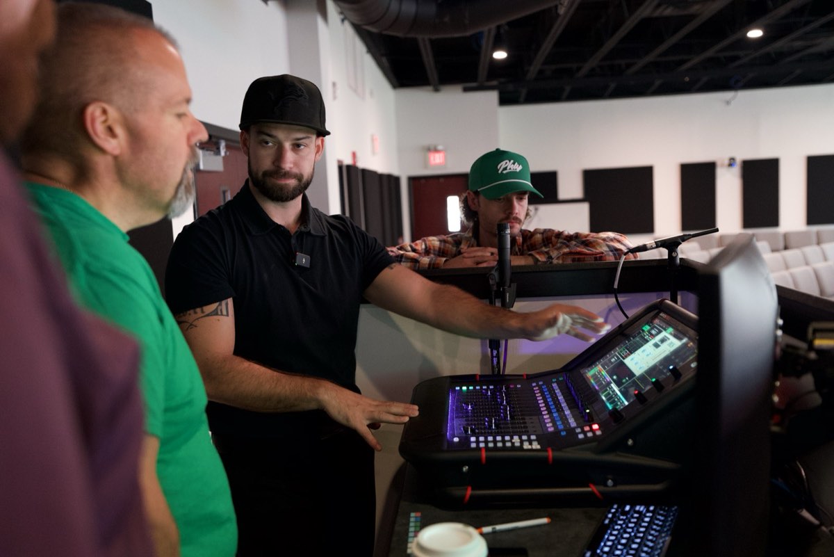 A Churchfront consultant coaching a church tech team at the console