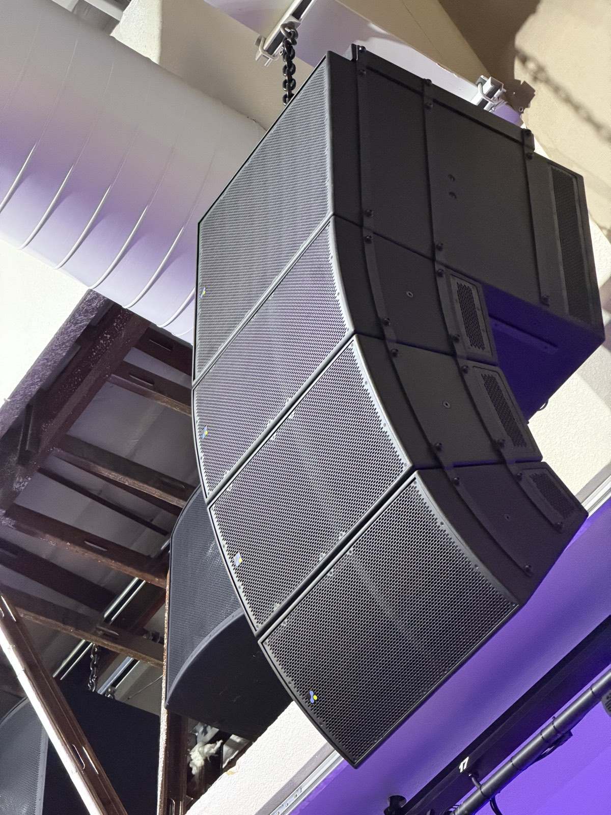 Flown line array loudspeaker hung above the seating at North Metro Church