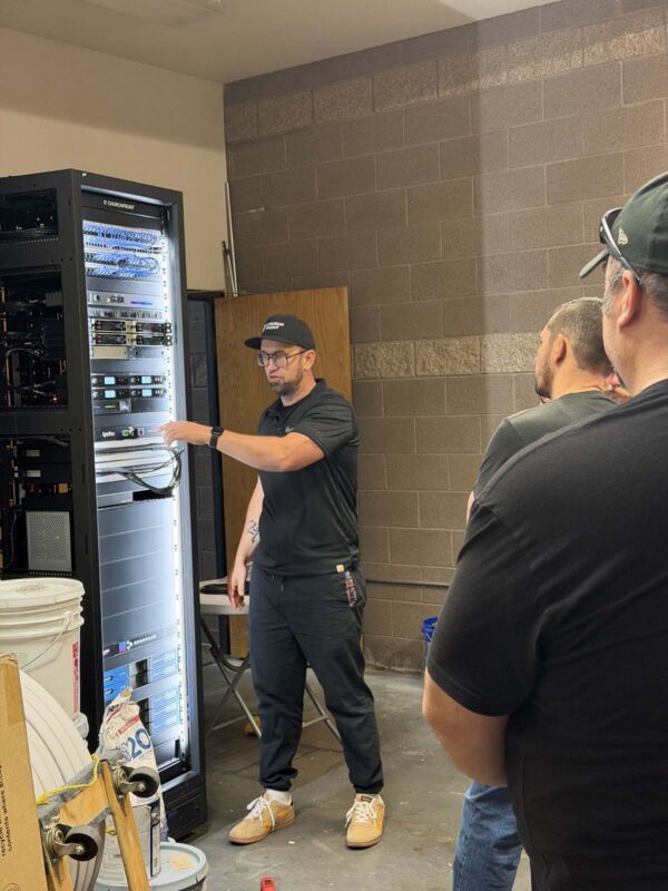 A Churchfront tech walking a church team through their equipment rack at North Metro Church