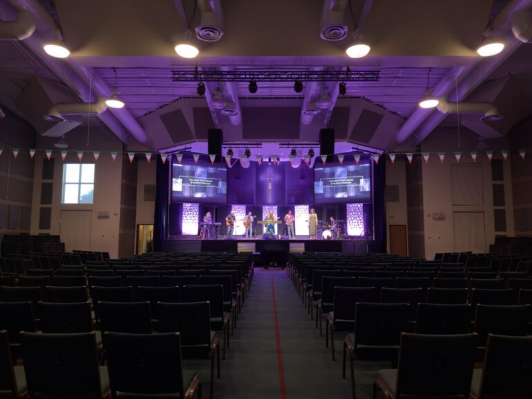 North Metro Church sanctuary with the stage lit for worship, viewed from the seating