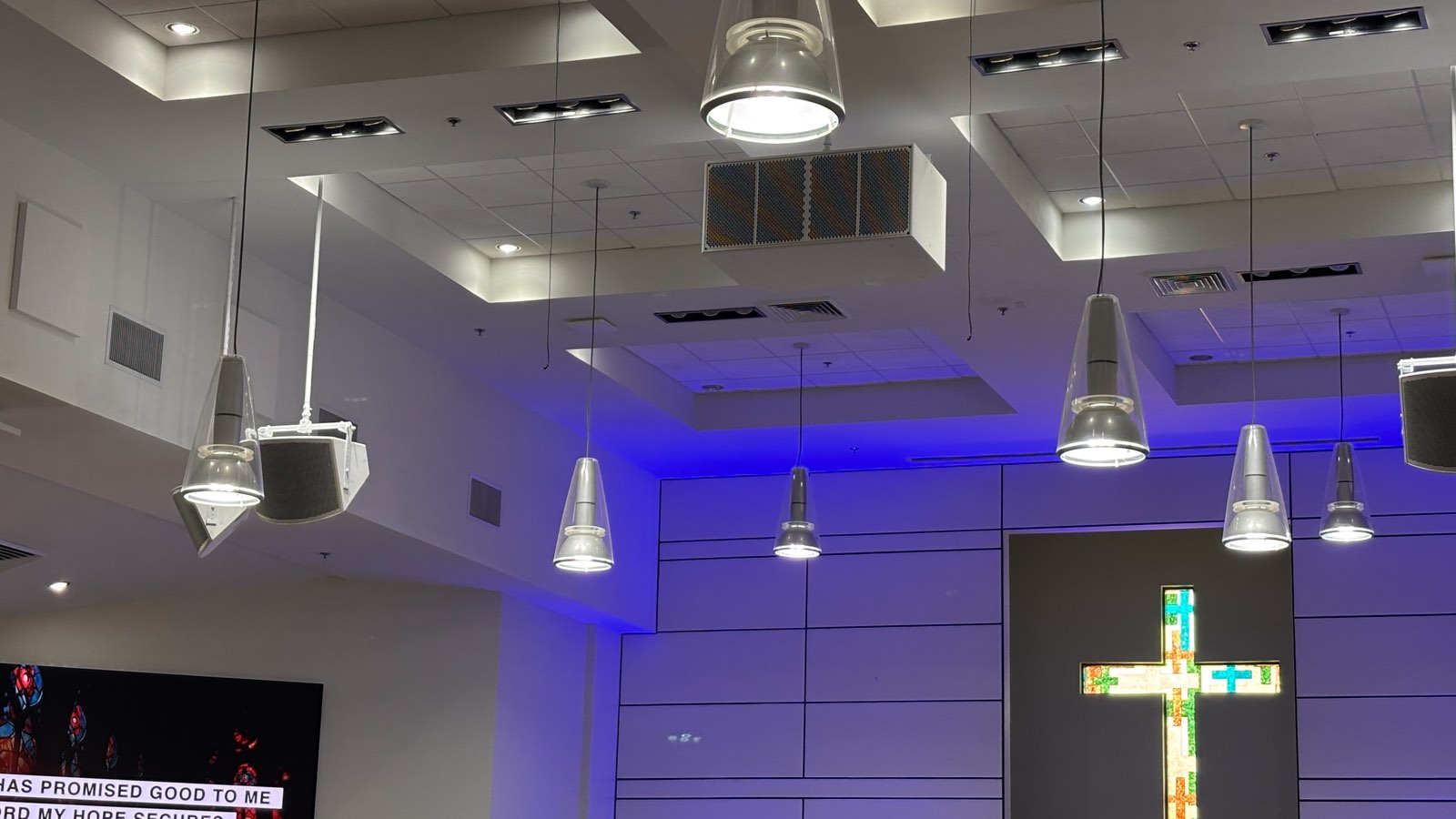 Flown Fulcrum Acoustic loudspeakers and pendant lights above the stained glass cross at Thunderbird Seventh-day Adventist Church