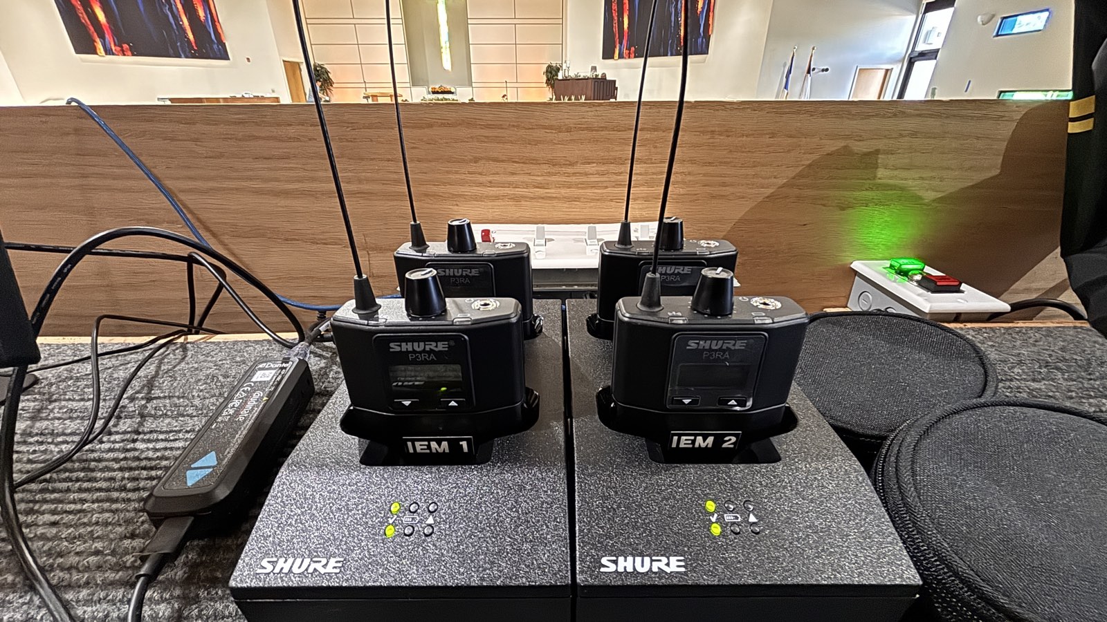 Shure PSM 300 P3RA bodypack receivers docked in charging stations at Thunderbird Seventh-day Adventist Church