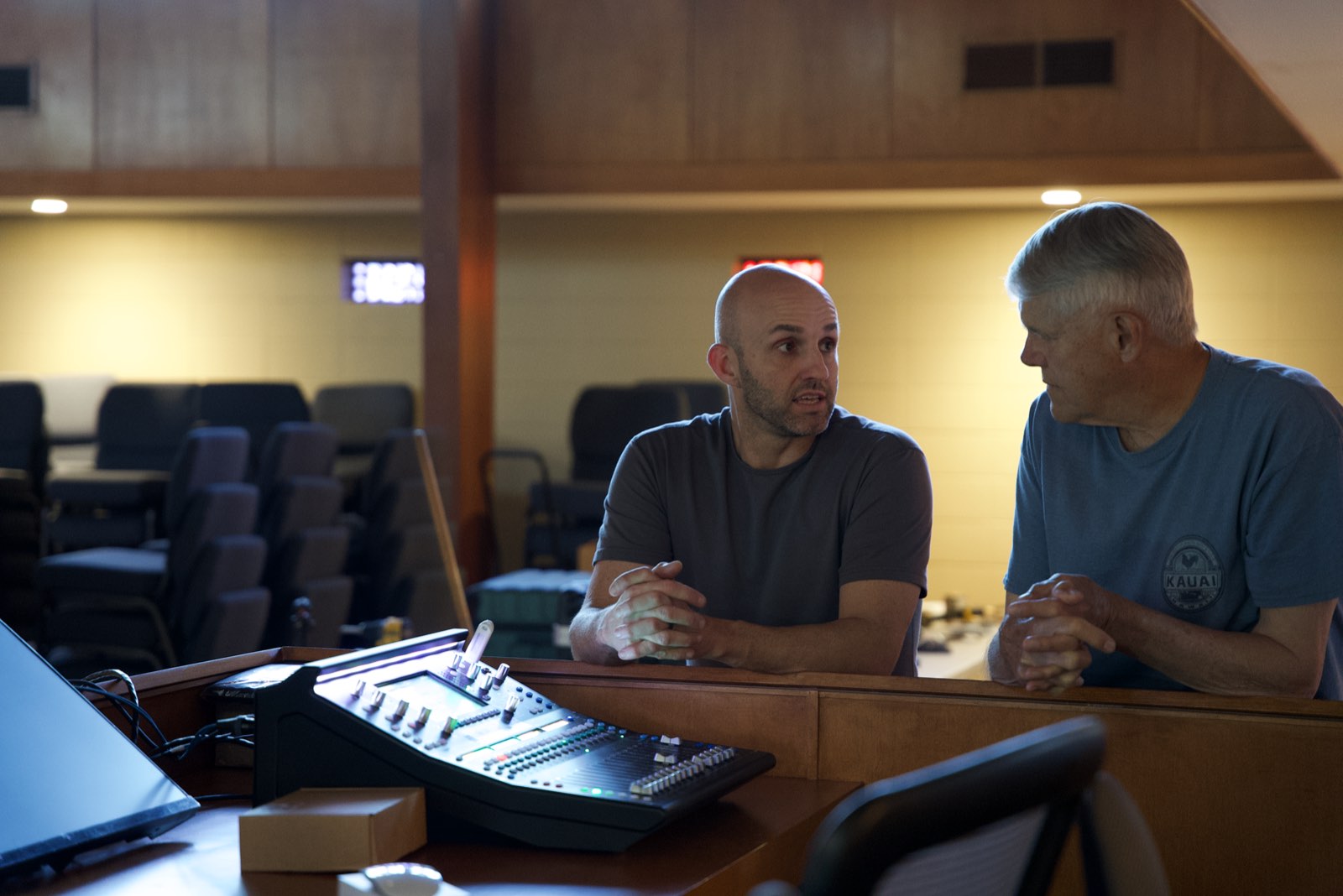Churchfront technician and a St. John's Lutheran team member talking at the front of house mixing position