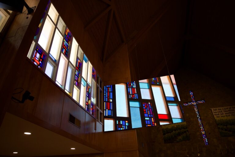 The St. John’s screens and stained glass seen along the length of the room