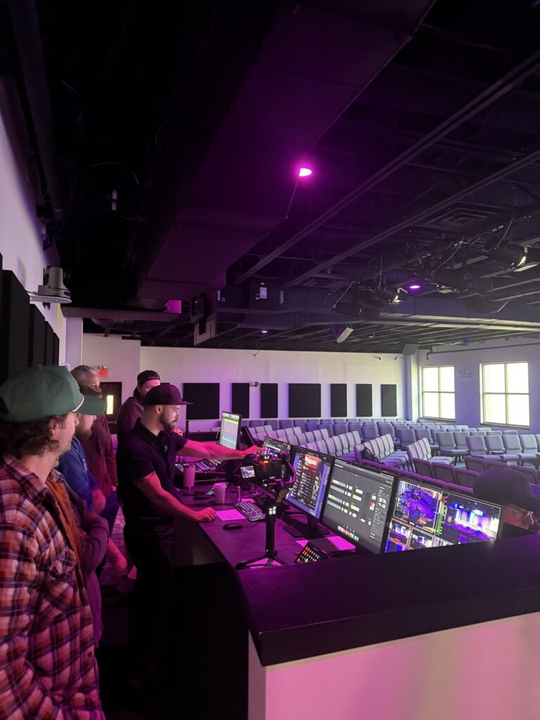 A Churchfront coach walking a church team through their system at the front-of-house booth