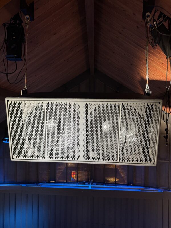 Loudspeaker flown in a traditional timber-ceilinged sanctuary