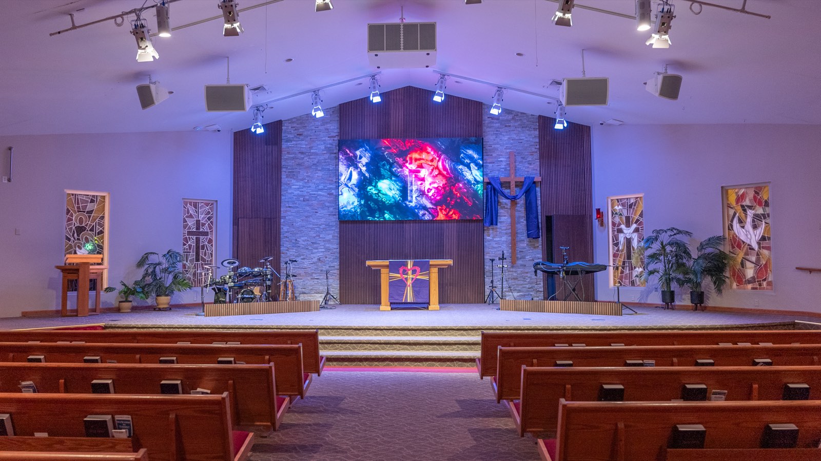 Trinity Church sanctuary seen from the center aisle with the LED wall, slat wall and stage lighting